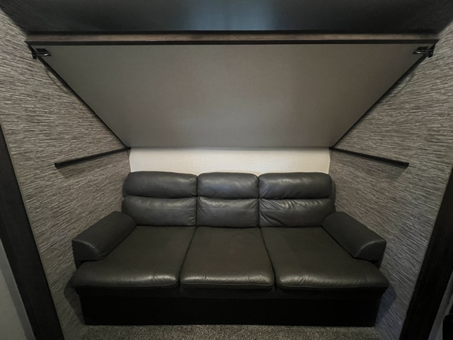 guest room has a davenport sofa couch under a hideaway top bunk
