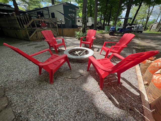 Red Mouskoka chairs around fire pit